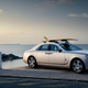 Image for article titled Someone Actually Commissioned a Surfboard With a 24-Karat Gold Trim to Pair With Their Rolls-Royce